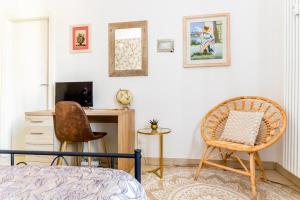 a bedroom with a bed and a desk and a chair at La finestra sulla fiera in Bologna