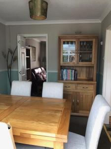 a dining room with a wooden table and chairs at Cosy House in Lovely Market Town in Newport