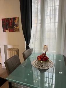 a glass table with a bowl of fruit on it at Casa Emma in Porto Ceresio