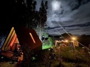 a view of a cabin at night with the moon at Casa Índigo Tabio in Tabio