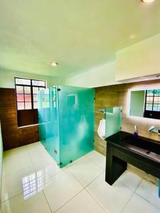 a bathroom with a glass shower and a sink at Rancho La Querencia in Tala +31 photos
