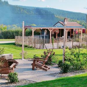 a park with a bench and a gazebo at Chalet, aux portes du Morvan in Voudenay-lʼEglise +40 photos