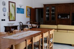 a dining room with a table and a couch at il Quadrifoglio camere in stile vintage in Cesena +19 photos
