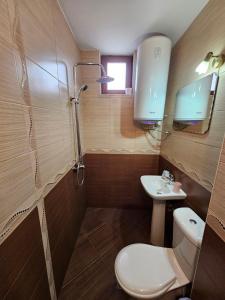 a bathroom with a toilet and a sink at Prime Apartments in Bansko