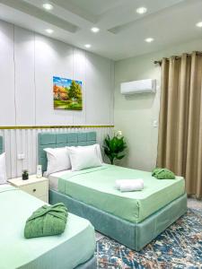 two beds in a hotel room with two bedsvisor at Tahrir Residence -"Marriage Certificate Required for Couples" in Cairo