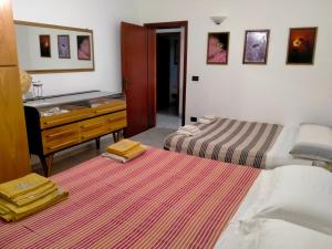 a bedroom with two beds and a sink and a dresser at il Quadrifoglio camere in stile vintage in Cesena