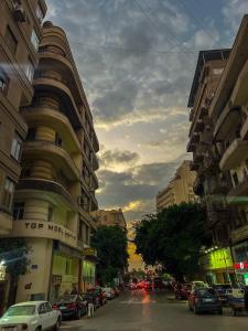 a city street with cars parked on the street at Tahrir Residence in Cairo +22 photos
