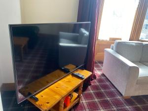 a living room with a large flat screen tv at 92 High Street in Aberlour