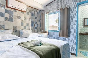 Cama ou camas em um quarto em Pousada Flor de Olinda