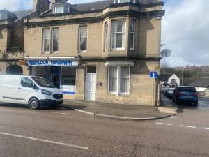 a white van parked in front of a building at 92 High Street in Aberlour
