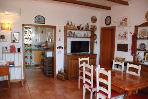 a dining room with a table and a television at villa lanterna in Conversano