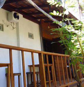 a house with a porch and a balcony at The Cinnamon Farm Wooden Cabana Unawatuna in Unawatuna