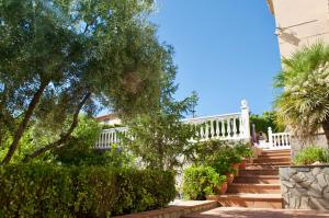 a set of stairs leading to a house with a white railing at El Chalete in Otura