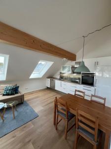 a living room with a wooden table and chairs at Ferienwohnung Neuwelt in Hinterzarten +10 photos