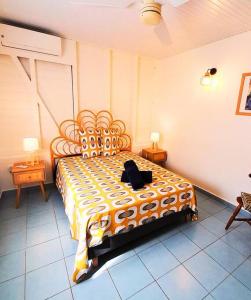 a bedroom with a large bed with a black bag on it at Villa Bod Lanmou in Port-Louis