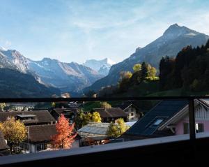 a view of a town with mountains in the background at Hidden Retreats The GlacierDoor in Frutigen