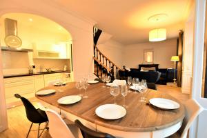 a wooden table with wine glasses on it in a kitchen at Hôtel particulier Le Trémolières in Cholet +20 photos