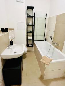 a bathroom with a sink and a tub and a toilet at Charming PalaisGreen Oldtown,Porzellanmanufaktur 2SZ in Meißen