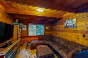 a living room with a couch and a television at The Beanstalk in Otis