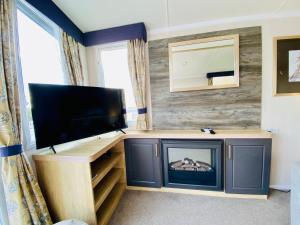 TV a/nebo společenská místnost v ubytování Beautiful Devon Cliffs Caravan, perfect for exploring Exmouth, Exeter & Sandy Bay beach
