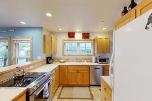 a kitchen with wooden cabinets and a sink at Pacific Shorepine in Pacific City