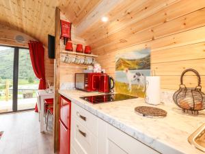 a kitchen with a counter top with a red microwave at Hartsop Magic - Crossgate Luxury Glamping in Penrith