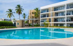 a swimming pool in front of a building at Sausalito | Pool View Retreat in Punta Cana