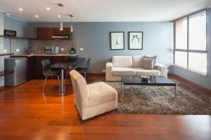 a living room with a couch and a table at Luxury Stay in Zona G King Bed 404 in Bogotá