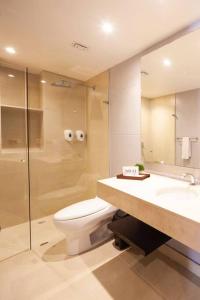 a bathroom with a toilet and a sink and a shower at Luxury Stay in Zona G King Bed 404 in Bogotá
