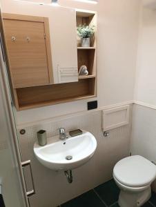 a small bathroom with a sink and a toilet at La Dolce Vita, Vomero in Naples +17 photos
