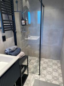 a bathroom with a shower and a sink at Apartment- fjord view, big terrace, close to Moa in Ålesund