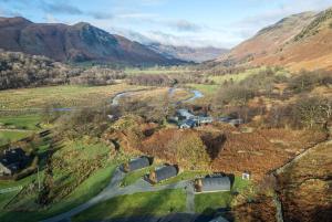 an aerial view of a valley with a river and mountains at Lovies Place - Crossgate Luxury Glamping in Penrith