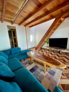 salon z niebieską kanapą i stołem w obiekcie El Mangle Suite Front Beach w mieście Ayampe