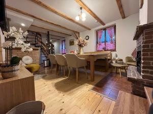 a living room with a wooden table and chairs at Chata Margitka in Dúbrava