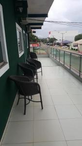 a row of chairs sitting on a train platform at Hotel Graciosa Palace in Palmas