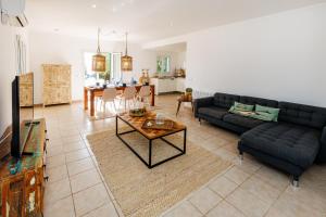 a living room with a couch and a table at Casa Colom in Portocolom