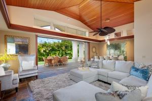 a living room with white furniture and a ceiling fan at ❤PiH❤ Aloha Palms~ Fully Detached Home Beach Gear Bikes in Waikoloa