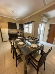 a dining room with a table and chairs and a kitchen at Amplio Departamento Céntrico in Formosa