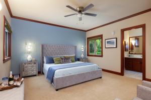 a bedroom with a bed and a ceiling fan at PiH: Aloha Palms~ Fully Detached Home Beach Gear Bikes in Waikoloa +32 photos