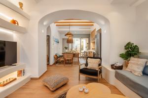 a living room with a couch and a table at Aethrion Boutique Apartment in Naxos Chora