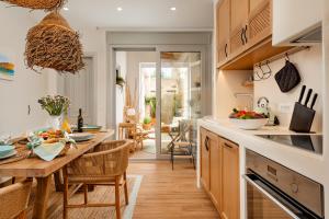 a kitchen with a table and a dining room at Aethrion Boutique Apartment in Naxos Chora