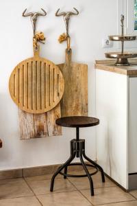 a wooden chair and a stool in a kitchen at Casa Colom in Portocolom