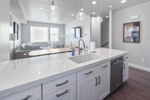 a kitchen with a sink and a living room at Silver Creek Sanctuary - Relax & Explore Park City in Park City +24 photos