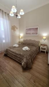 a bedroom with a large bed with two towels on it at Diamantea in Monopoli