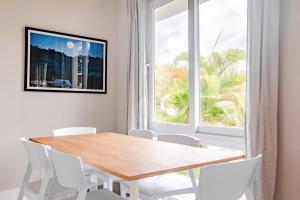 a dining room with a table and chairs and a window at Family Perfect Getaway 3BR Villa 6 at Playa Venao in Playa Venao