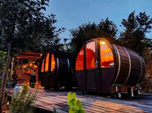 two igloo homes sitting on a deck at night at Glamping Il Rifugio dei Marsi in Ascoli Piceno