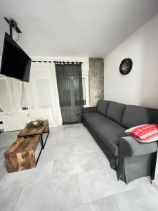 a living room with a couch and a table at Madrid Confort Suites in Madrid