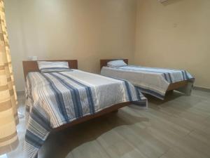Postel nebo postele na pokoji v ubytování Asante Beach Villa