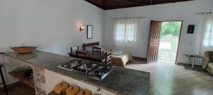 a kitchen with a counter and a stove top oven at Fazenda Pousada Cachoeira do Flávio in São Thomé das Letras