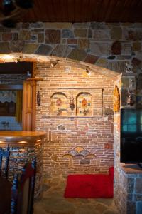 a brick wall with paintings on the side of it at Vila Elati Oreini Korinthia in Velína +65 photos